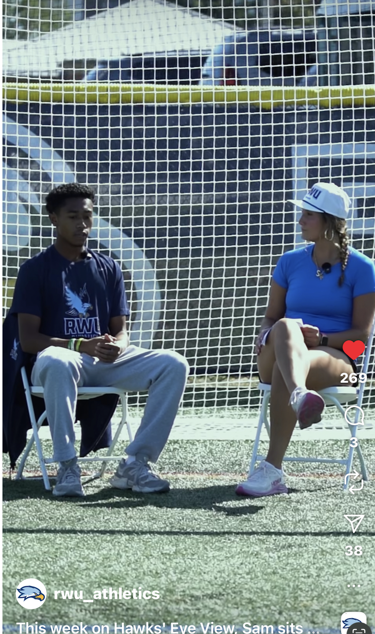 girl and boy sitting in front of a soccer net 